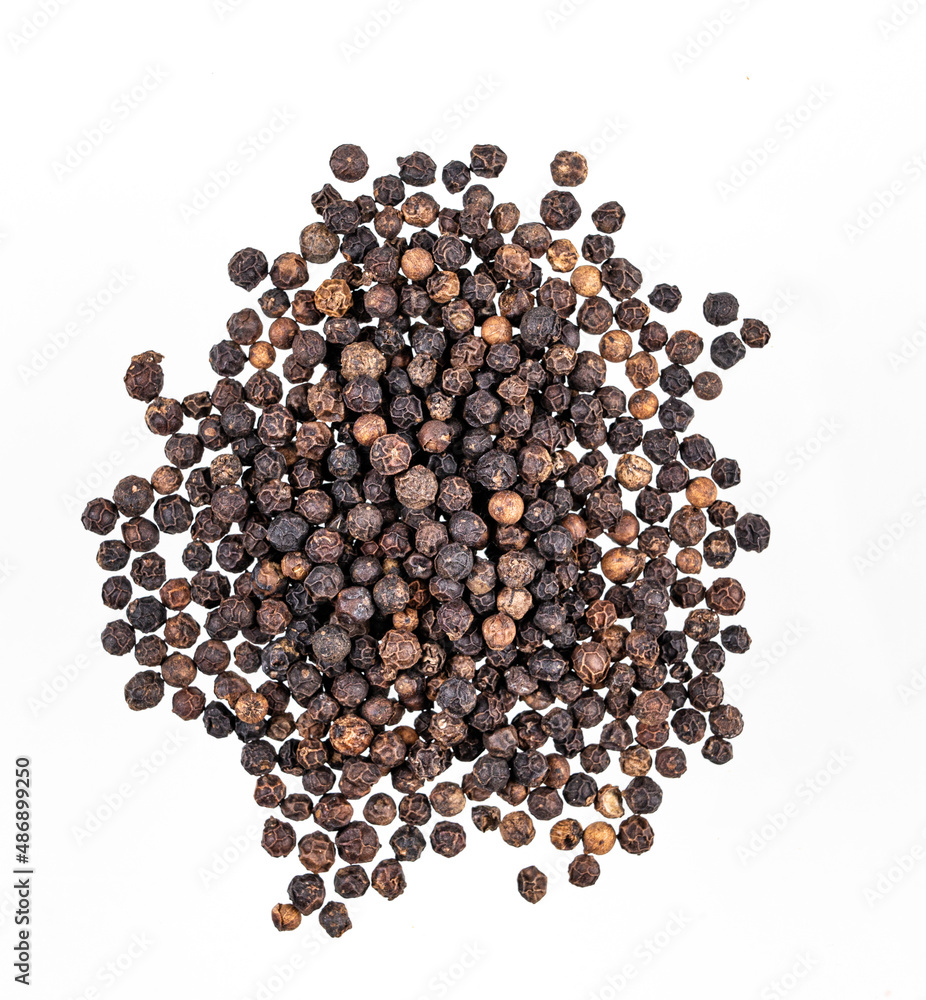 Aroma spice black pepper is scattered on a white isolated background. Top view Aroma spice black pepper is scattered on a white isolated background. Top view