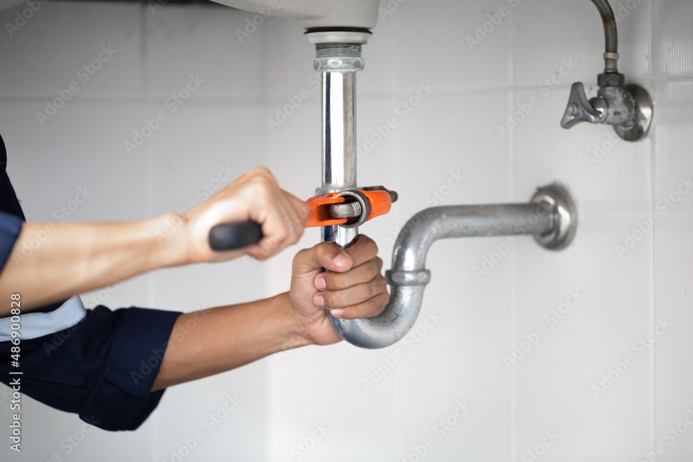 plumber at work in a bathroom, plumbing repair service, assemble and install concept. plumber at work in a bathroom, plumbing repair service, assemble and install concept.