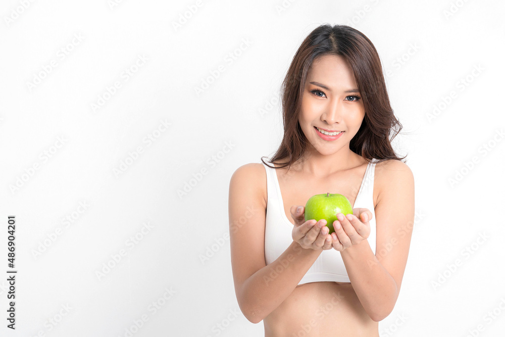 Beautiful asian young woman healthy food wearing white underwear holding green apple with healthy food isolated on a white background. Beautiful asian young woman healthy food wearing white underwear holding green apple with healthy food isolated on a white background.
