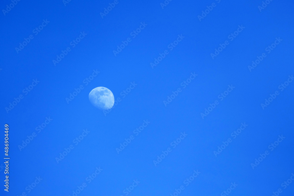 very blue sky and white moon, view of the moon in the daytime sky very blue sky and white moon, view of the moon in the daytime sky