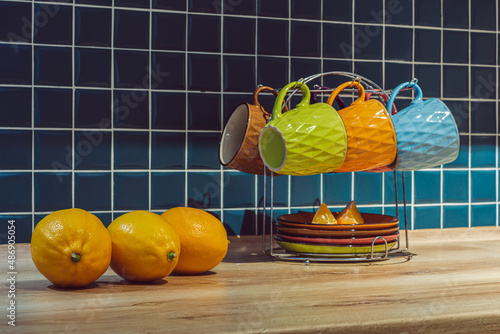 three yellow lemons in the kitchen and a tea set