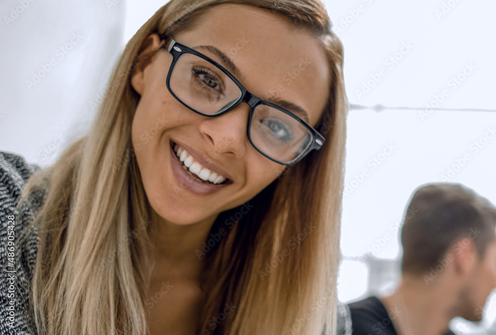 the girl is smiling and looking at the monitor the girl is smiling and looking at the monitor