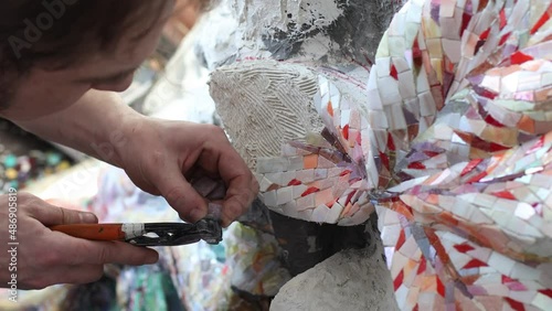 Workplace mosaics master making smalt glass mosaic panel. Man mosaicist at work class