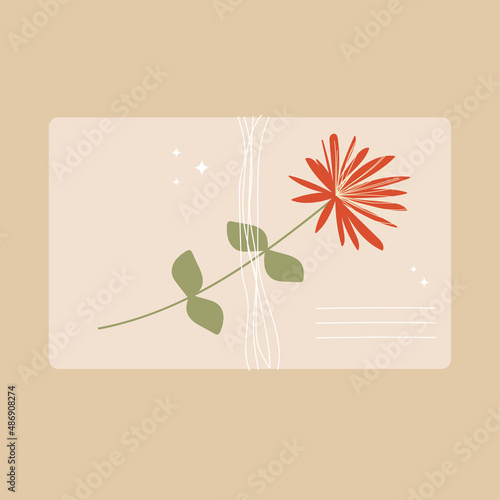 An envelope tied with a thread of kraft paper with a wildflower.