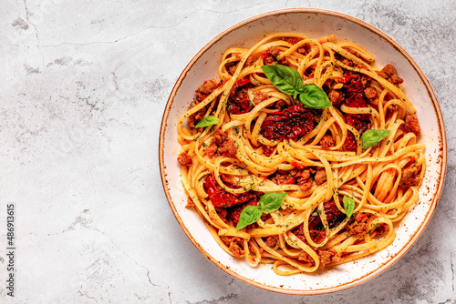 Pasta with bolognese sauce and sun-dried tomatoes photo