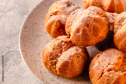 Homemade profiteroles with powdered sugar.