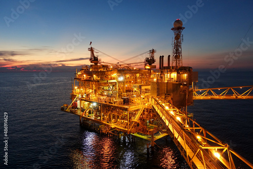 platform for exororation and production oil and gas with bridge in evening time for power energy of the wolrd concept