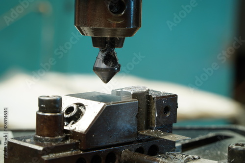 Obraz na plátně Countersink drill bit make sink in hole in steel billet,Chamfer Countersink