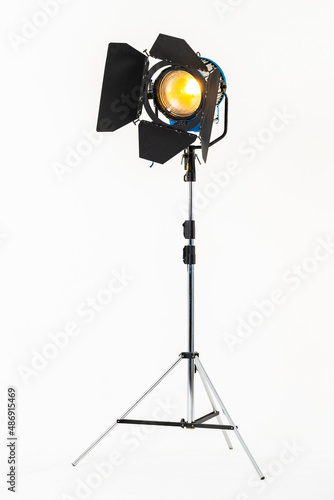 Professional film warm lighting, stage light with barndoors on a stand isolated on a white background