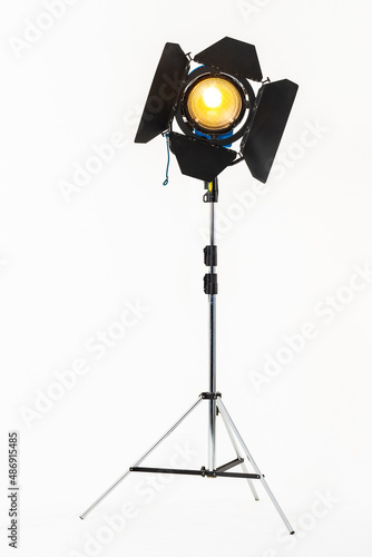 Professional film warm lighting, stage light with barndoors on a stand isolated on a white background photo