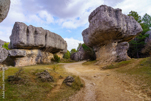 Huge stones in the form of mushrooms with a path in the forest of the Enchanted City of Cuenca.