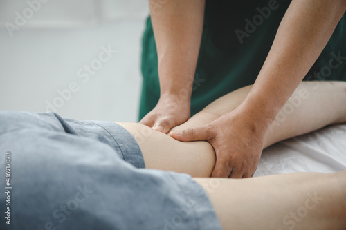 Consultation therapist with the treatment of treating injured knee of the patient with his therapist in clinic, sport physical therapy concept,