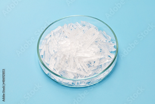 menthol crystals in a petri dish isolated on sky blue background