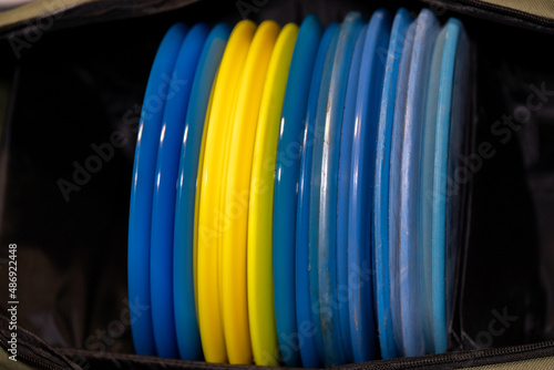 stack of colorful disc golf discs photo