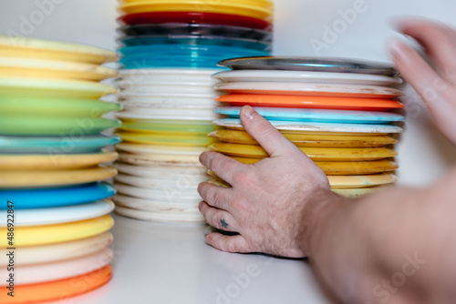 hand picking up disc golf discs photo