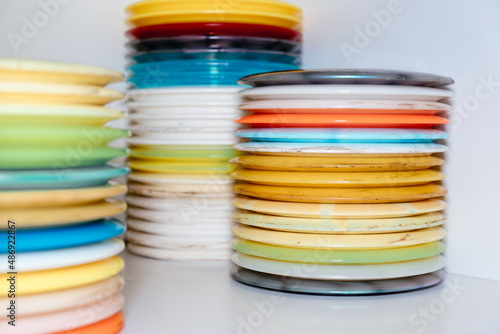stack of colorful discs and frisbees in stock