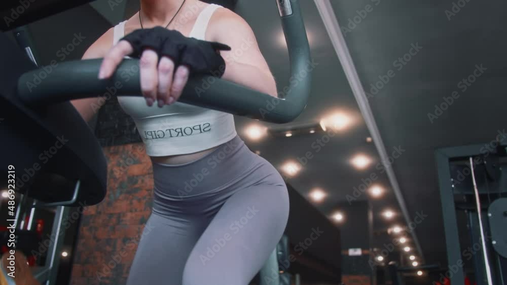 two women in tracksuits are in the gym on sports equipment, one of the women is a professional sports trainer. coach giving instructions two women in tracksuits are in the gym on sports equipment, one of the women is a professional sports trainer. coach giving instructions
