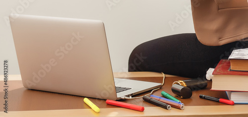 Wallpaper Mural closeup hands of business woman working on laptop and making notices in her notebook on wooden table Torontodigital.ca
