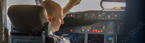 Foto Focused professional pilot sitting in an airplane cabin, ready for takeoff