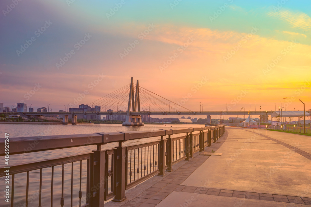 Millennium Bridge in Kazan, Russia. Cable-stayed bridge across the river. View from the Kremlin embankment. Beautiful city view at dawn. Panoramic view 