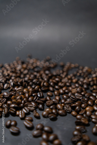 Pile of roasted coffee beans with dark gray background