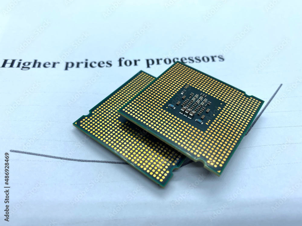 Two microprocessors on a paper written higher prices closeup view Two microprocessors on a paper written higher prices closeup view
