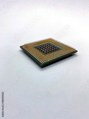 Obraz na plátně Single microprocessor with pins up closeup view isolated on white