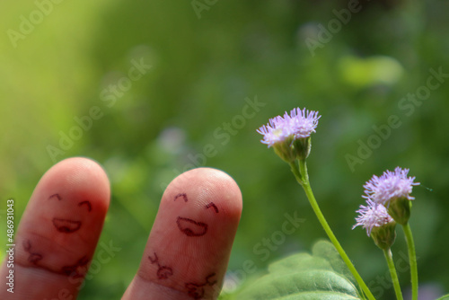 two finger and flower with emoticon smile as background 