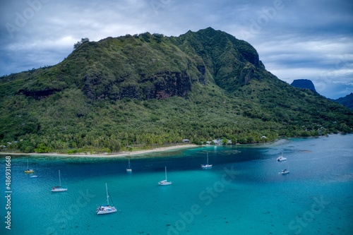 Cove with boats and tropical mountain in background 