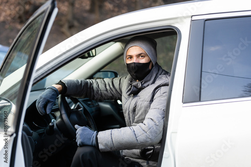 health protection, safety and pandemic concept - male taxi driver wearing face protective medical mask