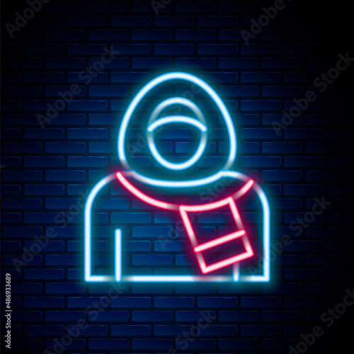 Glowing neon line Muslim woman in hijab icon isolated on brick wall background. Colorful outline concept. Vector