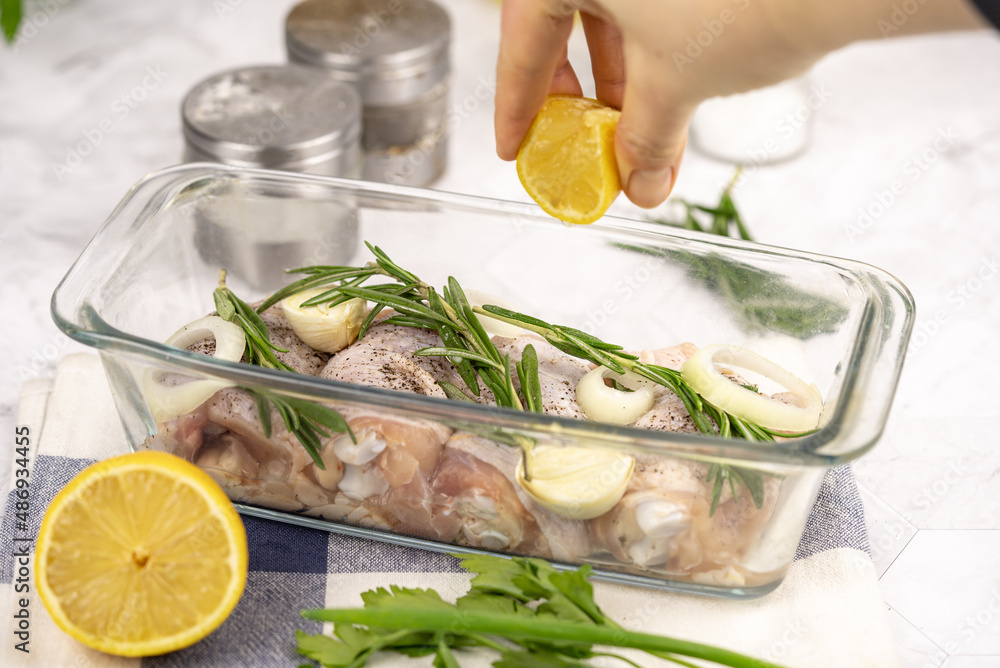 Raw chicken drumstick on a table. Chicken cooking in a kitchen. Raw chicken thigh on white background. Raw chicken drumstick on a table. Chicken cooking in a kitchen. Raw chicken thigh on white background.