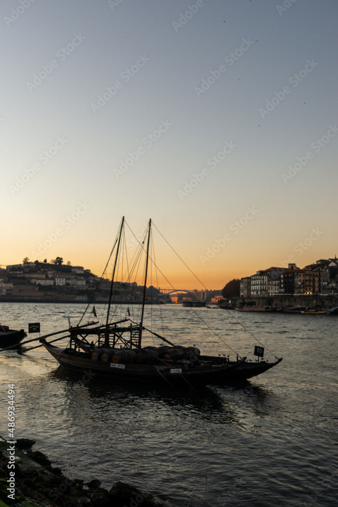 Boats called Rabelos, on the Douro river in Porto, and in the background the sunset.