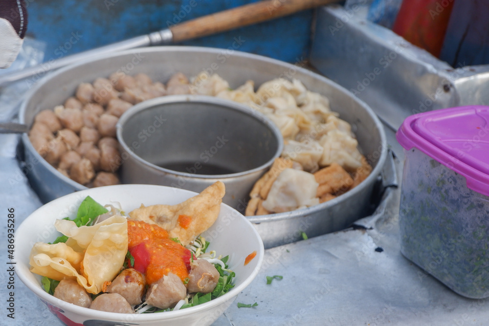 Meatballs in a bowl with tofu and crackers for sale at a food festival