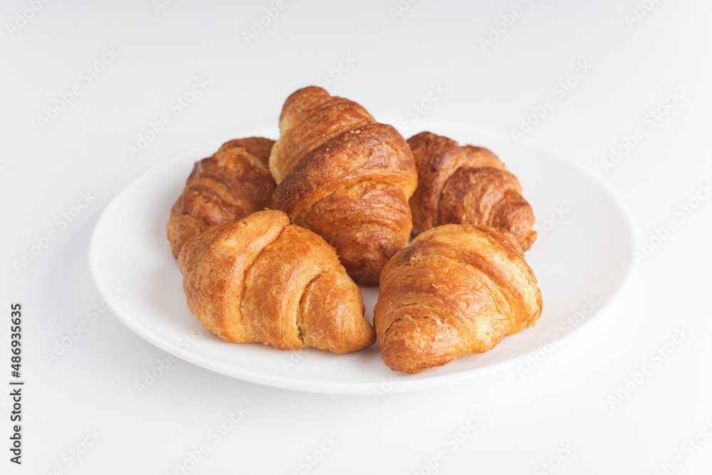 Fresh delicious croissants on a white background. French pastries. Croissants are isolated.