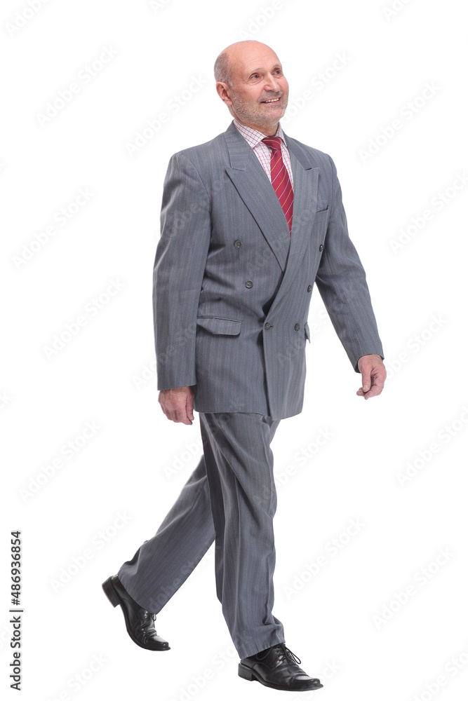 full length picture of a senior business man walking towards the camera and smiling. full length picture of a senior business man walking towards the camera and smiling.