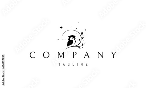 Vector logo on which an abstract image of a cute owlet sitting on a tree against the background of stars.
