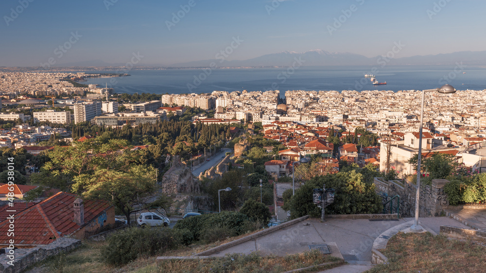 Cityscape with downtown, living neighborhoods, sea and mountains in a haze, Thessaloniki, Greece