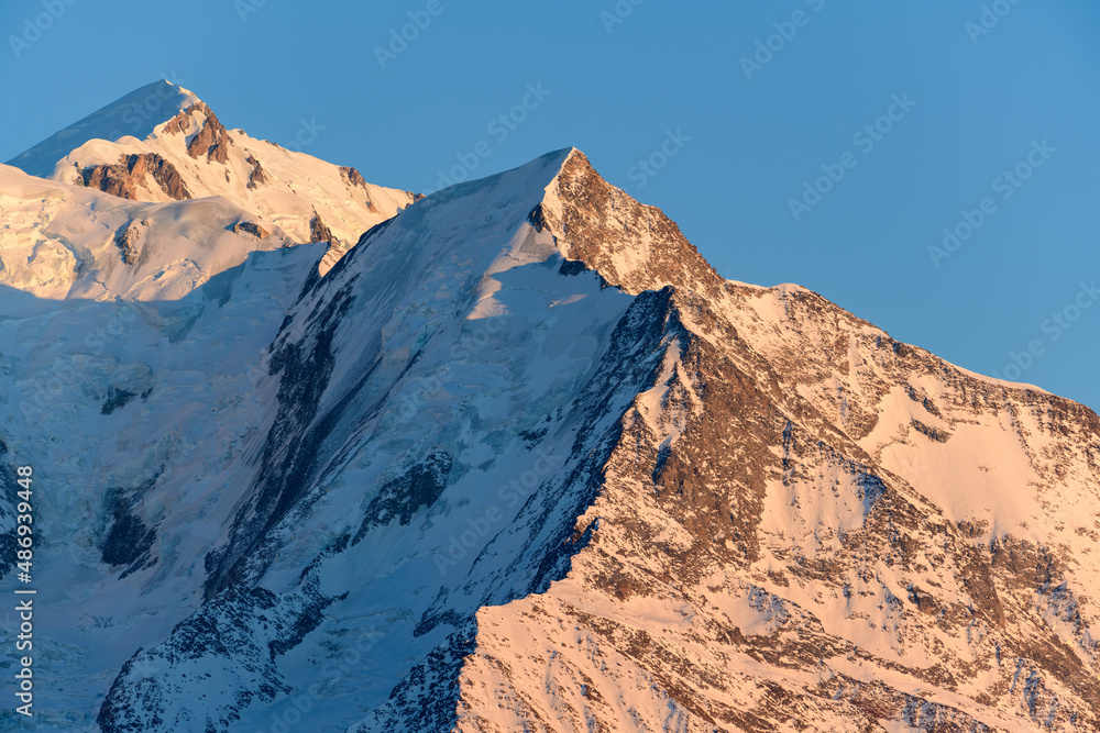 The Aiguille de Bionnassay lit by the Sun in Europe, France, Rhone Alpes, Savoie, Alps, in winter on a sunny day.
