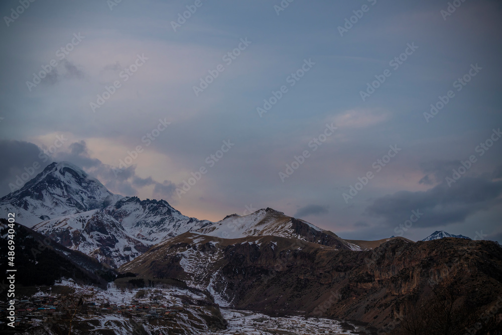 High snow covered mountain Kazbek at the sunrise.  Winter mountains landscape. Georgia,  Kazbegi.