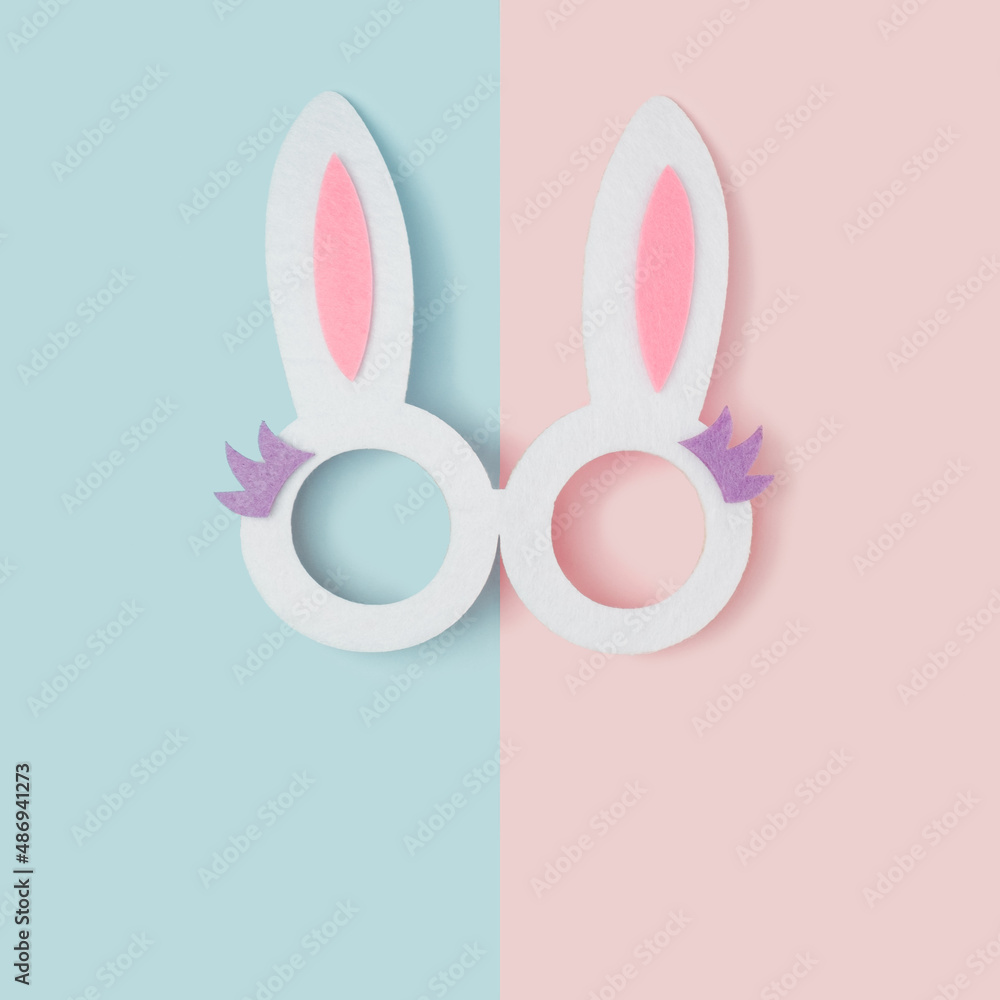 Bunny ears glasses on a two tone pastel background. Happy Easter minimal concept. Bunny ears glasses on a two tone pastel background. Happy Easter minimal concept.