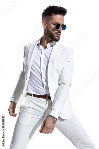 attractive young guy in white suit with retro sunglasses looking to side © Viorel Sima