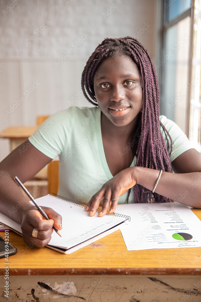 African high school girl having test at classroom. African high school girl having test at classroom.