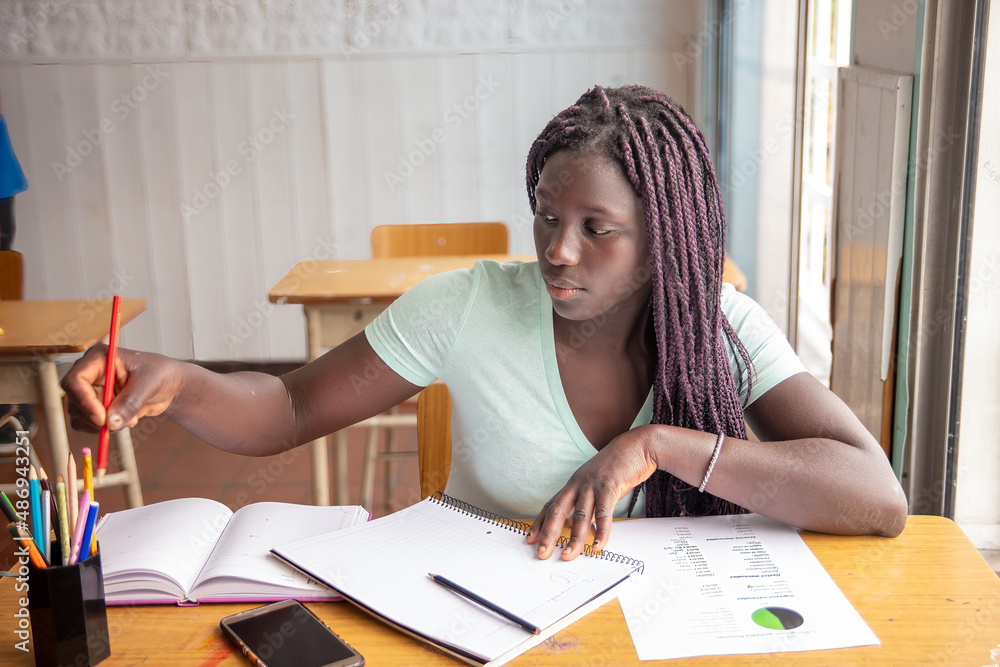 African high school girl having test at classroom. African high school girl having test at classroom.