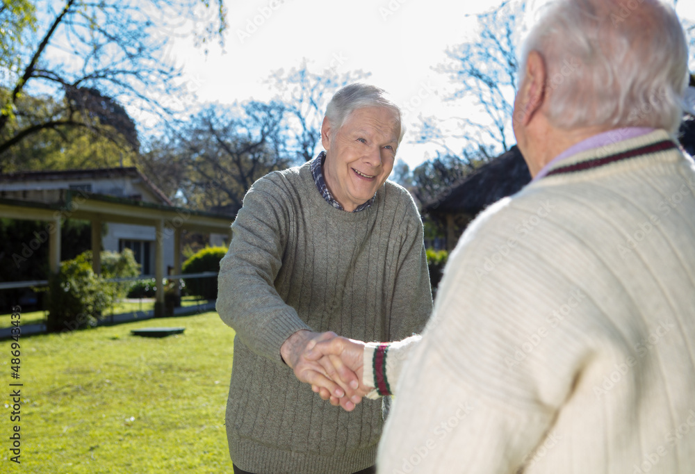 Caucasian seniors making acquaintance outdoor. Retired elderly people living their life at its best. Caucasian seniors making acquaintance outdoor. Retired elderly people living their life at its best.