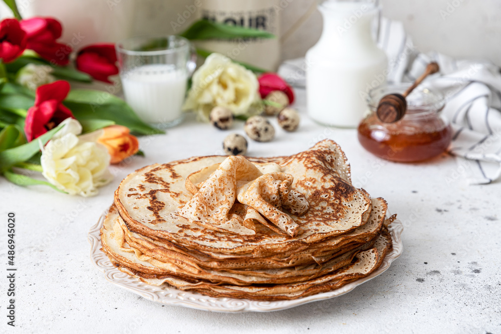 Stack of traditional russian pancakes blini on wooden background. Maslenitsa traditional Russian festival meal.