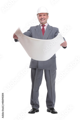 Smiling businessman in white hardhat blueprint and looking at camera