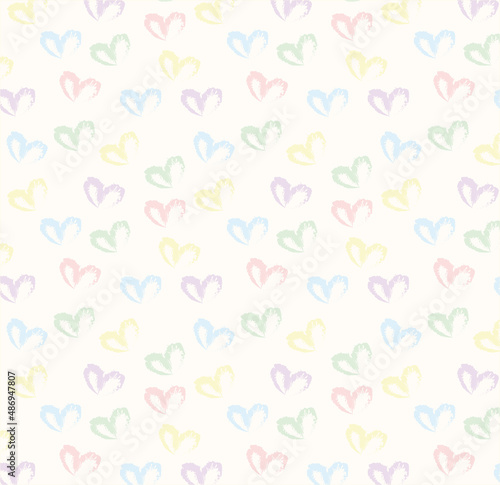 Seamless pattern of hand drawn hearts in pastel rainbow colors on beige and neutral background