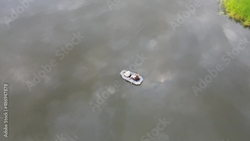 Russia, Volga, 07.08.2021. People in a boat float on the river in sunny weather, aerial video. Water recreation concept. editorial use only.
