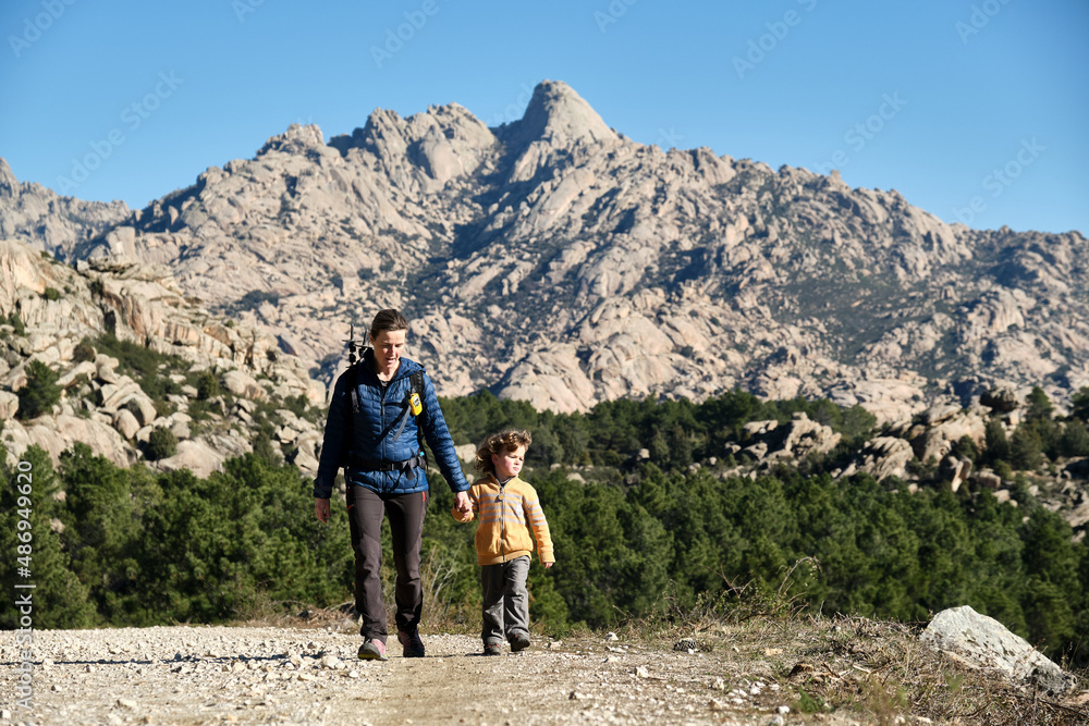 Family hiking in the mountains. A mother and her son take a hike together in the mountains